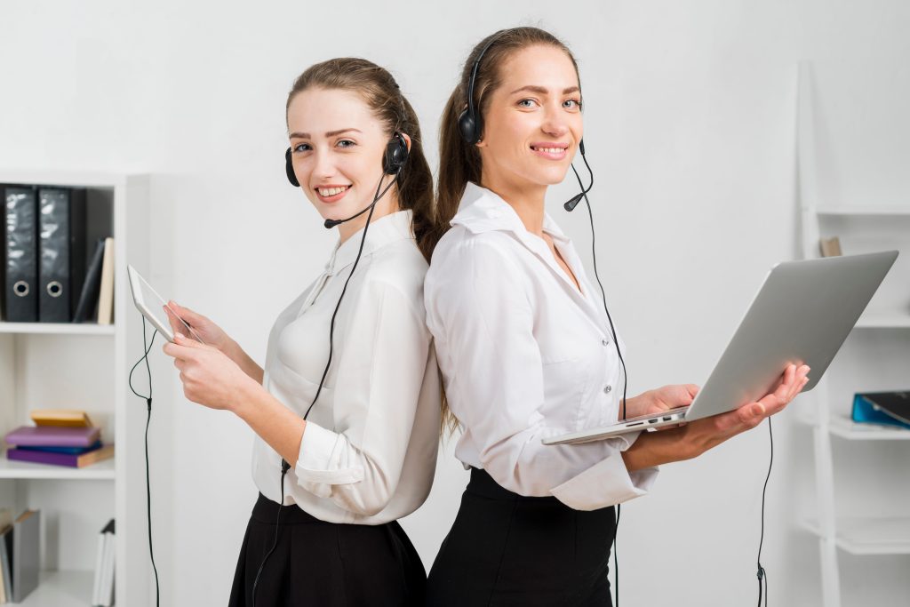 Professional virtual assistants providing customer support using headset and laptop in a modern office setup